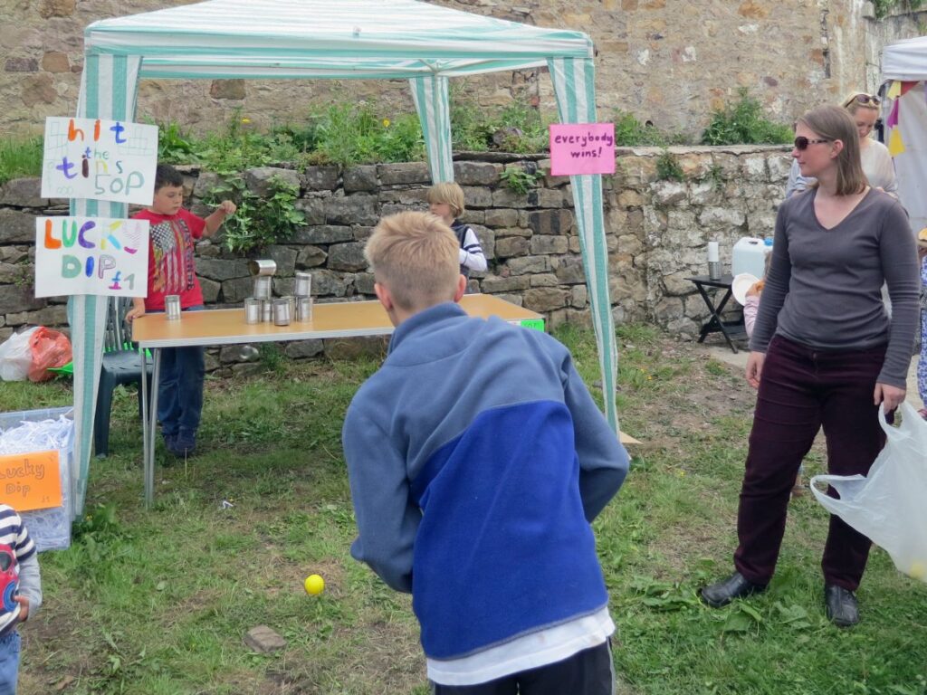 Throwing balls on the hit the tins stall