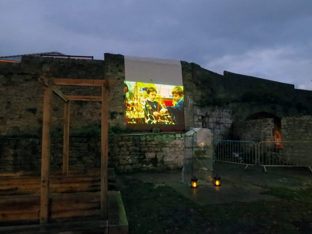 The Triangle at night lit up with coloured lights and lanterns