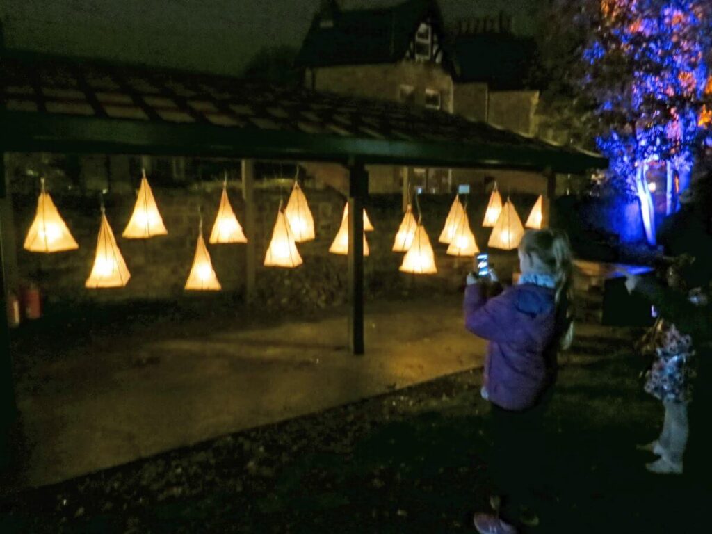 The Triangle at night lit up with coloured lights and lanterns