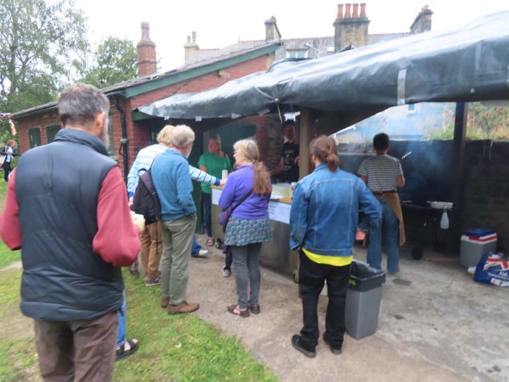 People queuing at BBQ- Triangle Summer Fair August 2025