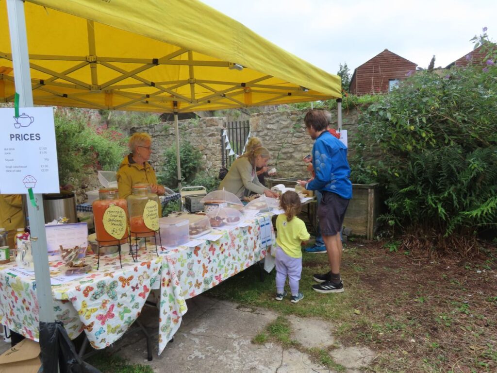 People at cake stall - Triangle Summer Fair August 2025