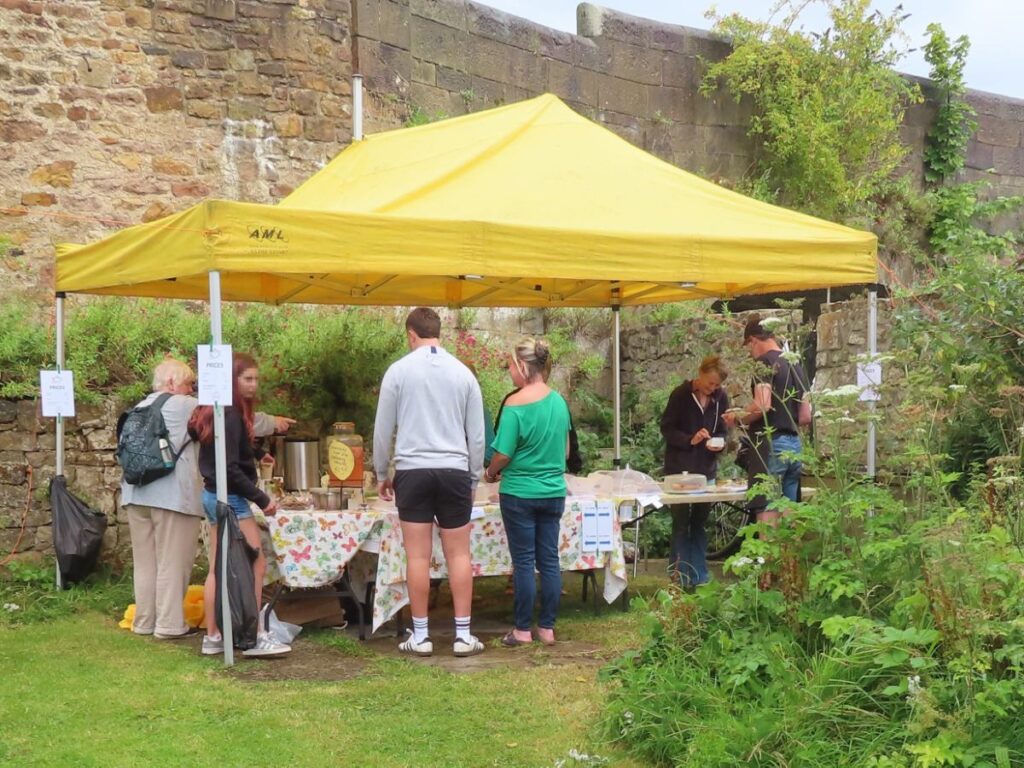 People at cake stall - Triangle Summer Fair August 2025